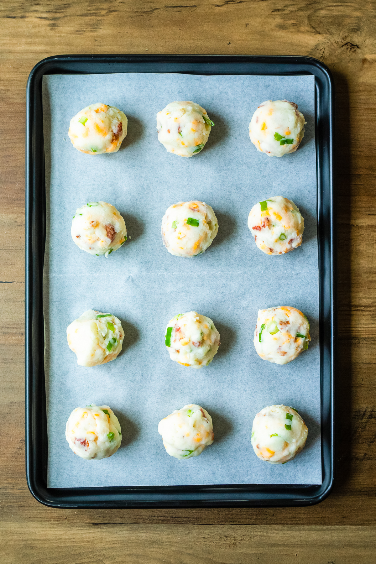 mashed potato balls on a baking sheet