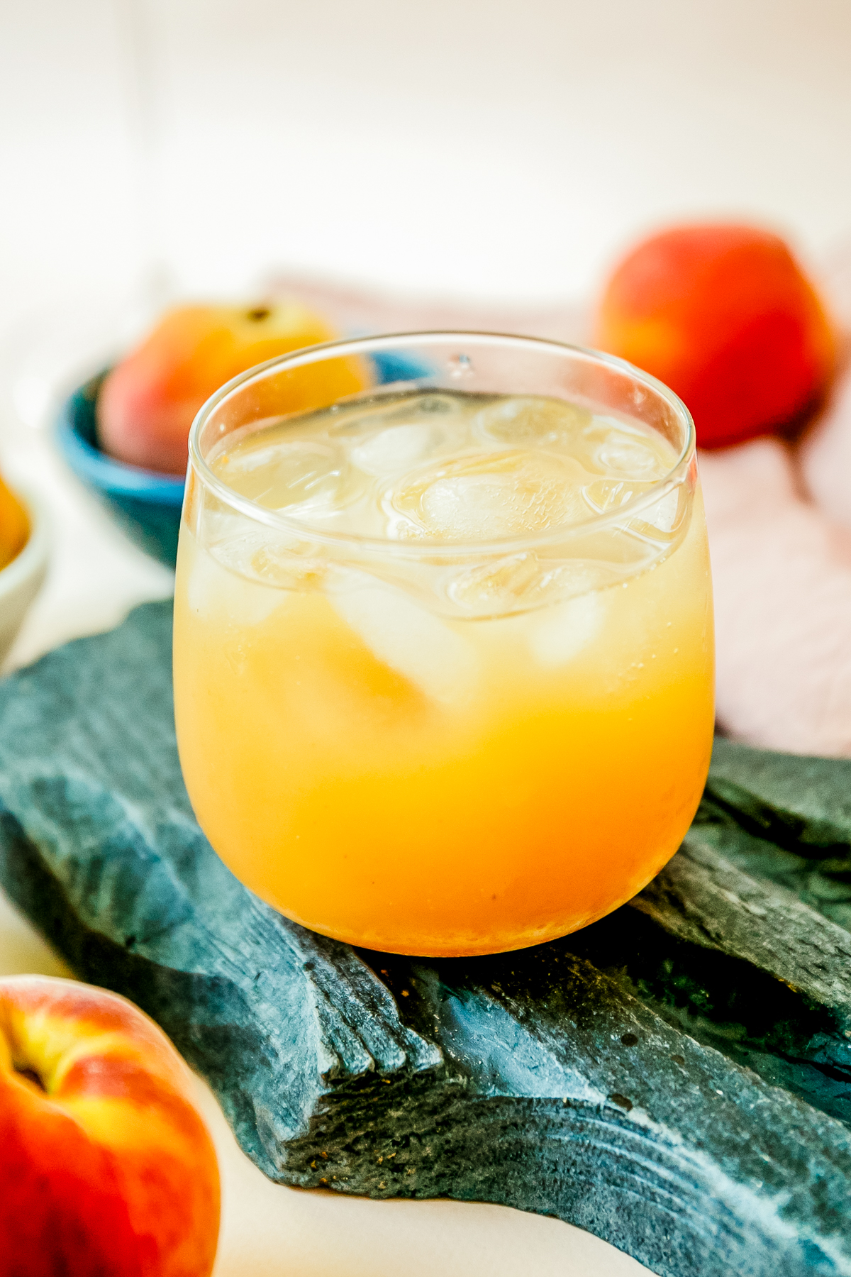 glass filled with copycat starbucks peach green tea lemonade